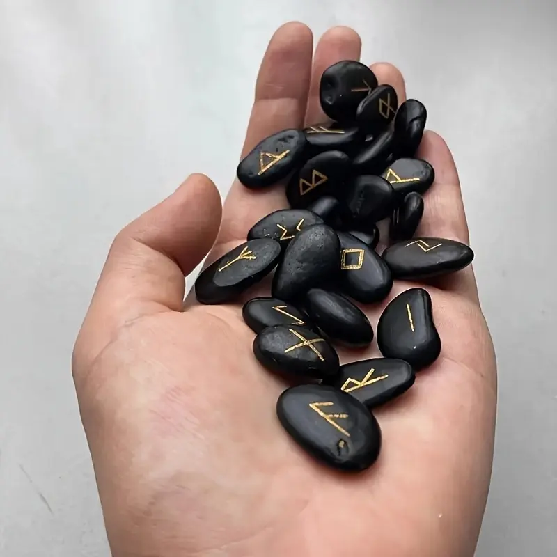 A Set of 25 Natural Black Pebbles Engraved with Ancient Letters, Accompanied by a Bag 1