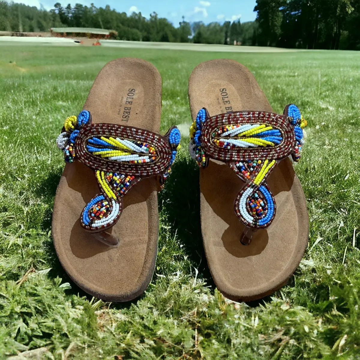 Colourful beaded knots on suede slippers