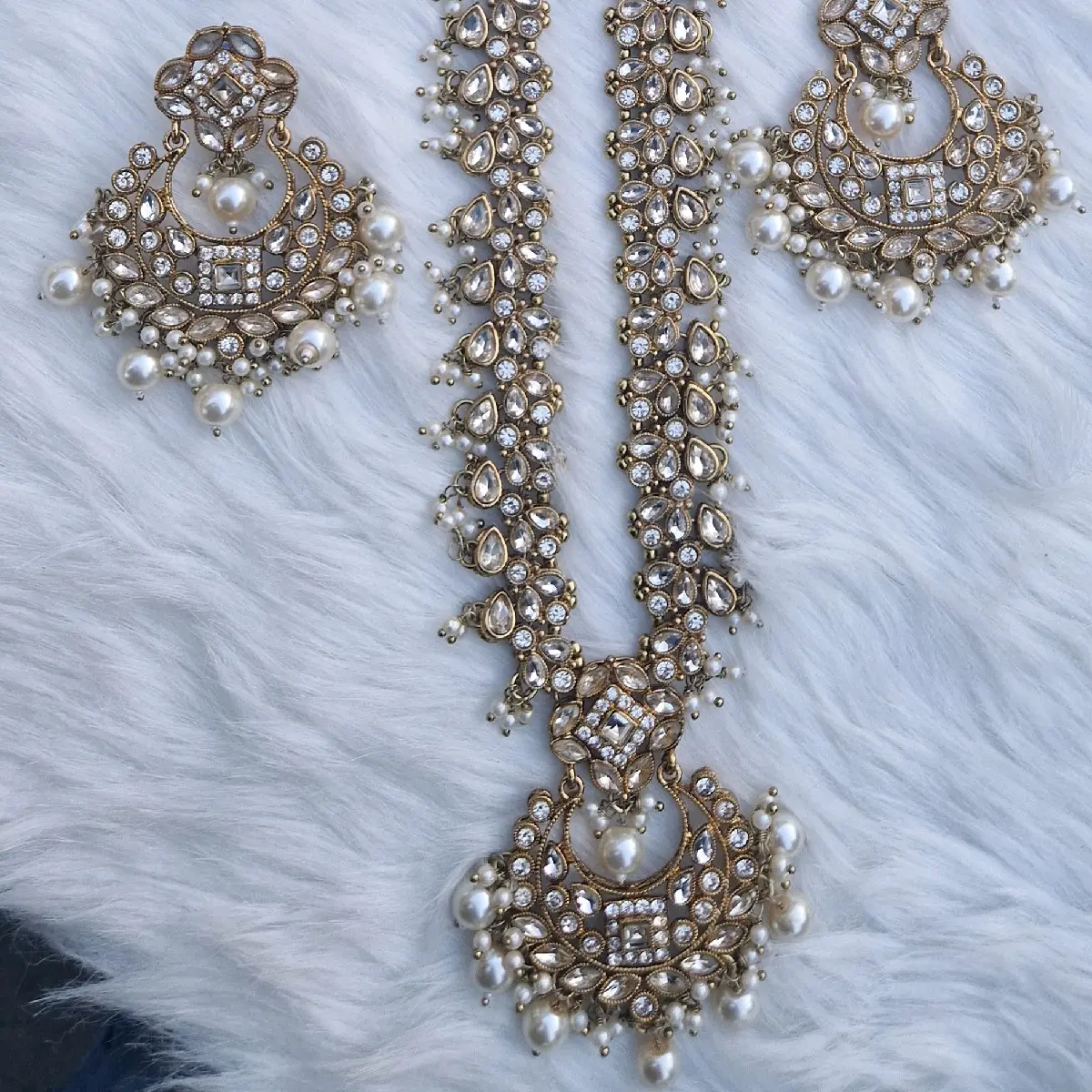 gold colour long necklace . comes with earrings and tika. very good quality.