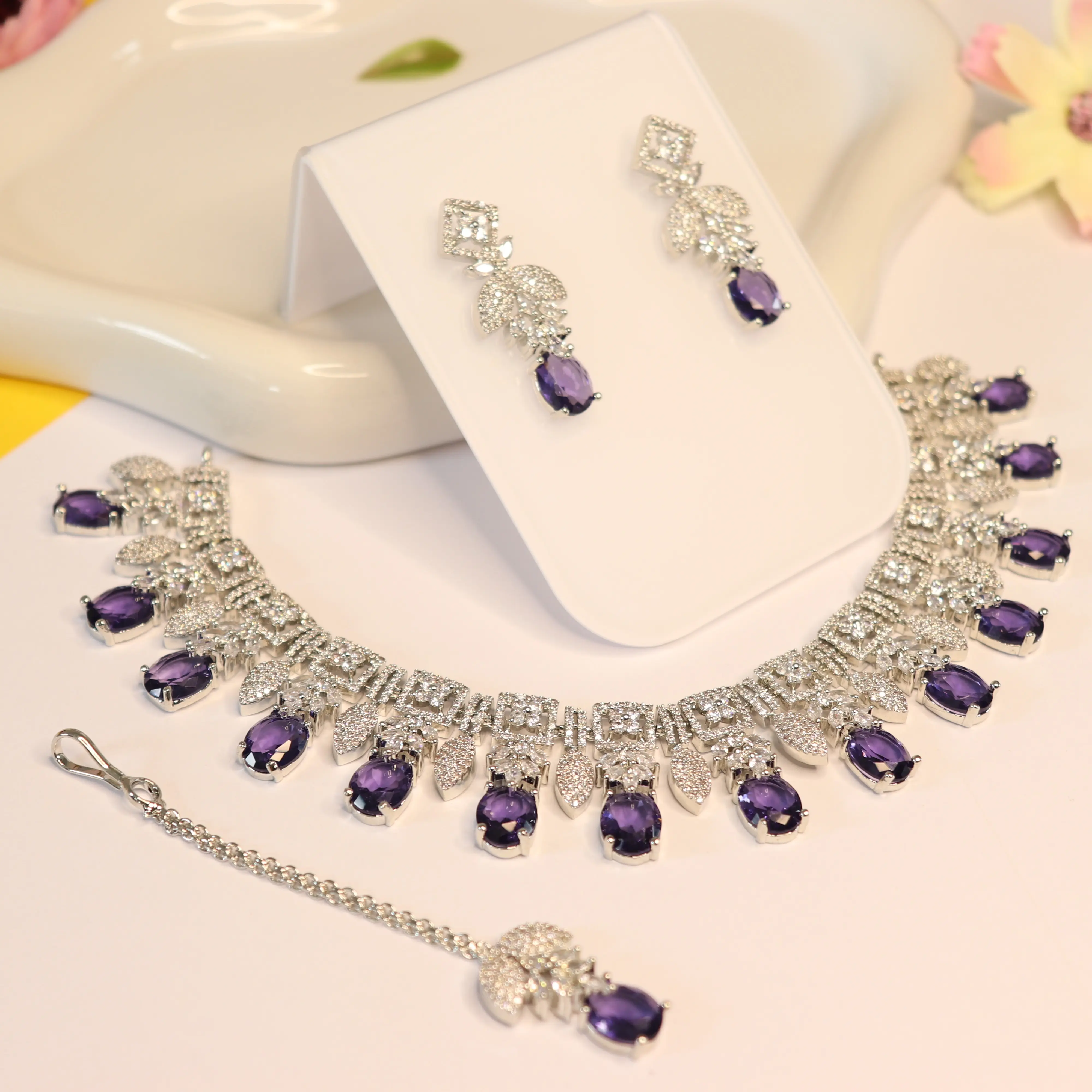 Grandeur neckless, Earring and Tikka set in Purple color AD stone in silver polish