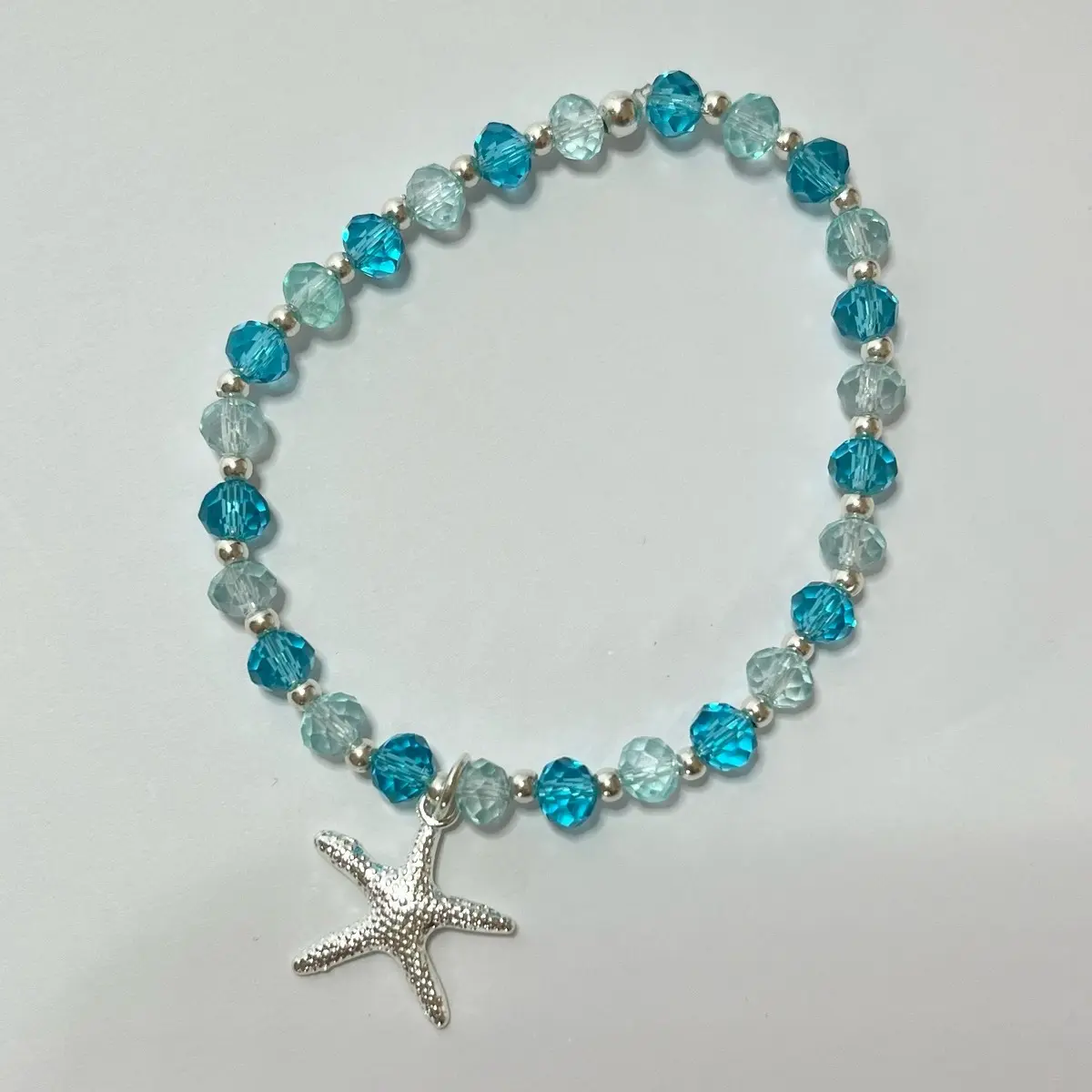 Blue glass bead stretchy bracelet with starfish charm approx. 7” but can be made to any size.