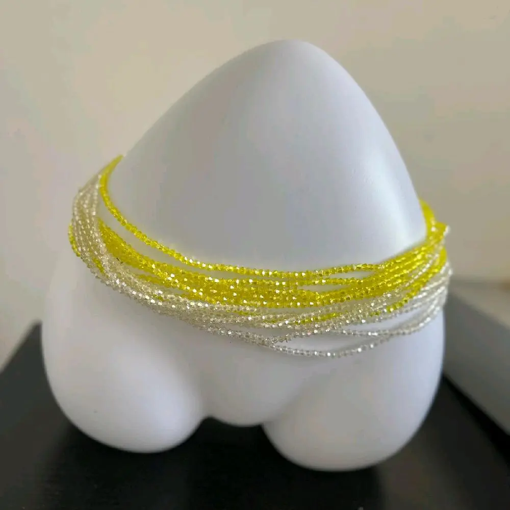 Elastic Clear crystal blends waistbeads for women. crafted  to beautify your waistlines in vibrant  yellow and glossy white *one size fit all*