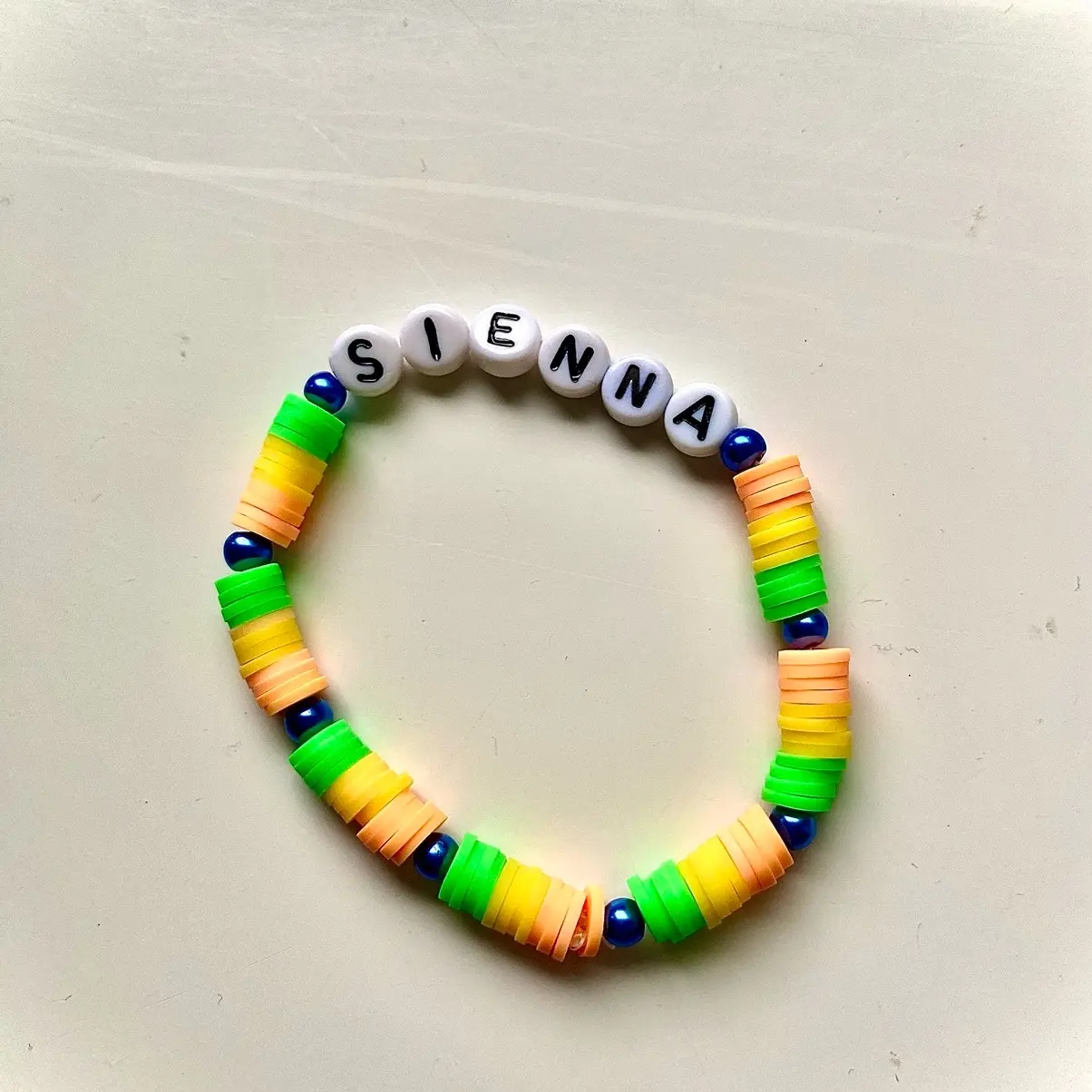 Personalised  orange, yellow and green claybead bracelet