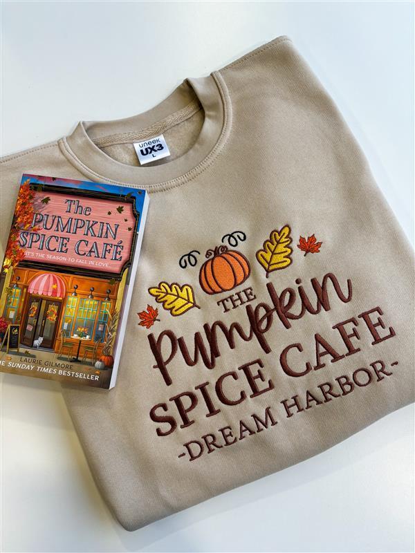 The Pumpkin Spice Café Official Embroidered Crew Neck Sweatshirt - A warm beige super-soft sweatshirt with embroidered details (a collegiate style centre slogan, a pumpkin & autumn leaves). Boxy fit, crew neckline, cuffed sleeves and bottom hem. 3