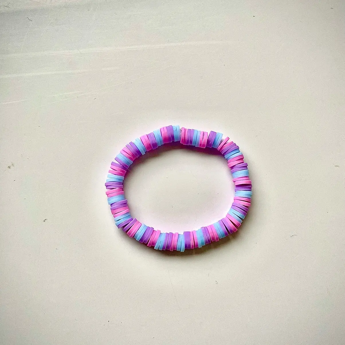 Colourful pink, purple and blue patterned clay bead bracelet