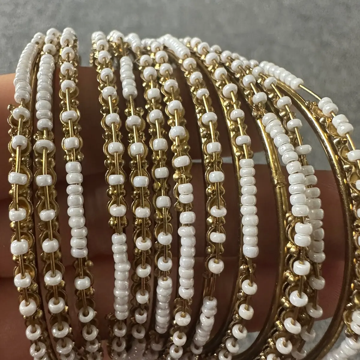 Gold and white bangles adult size