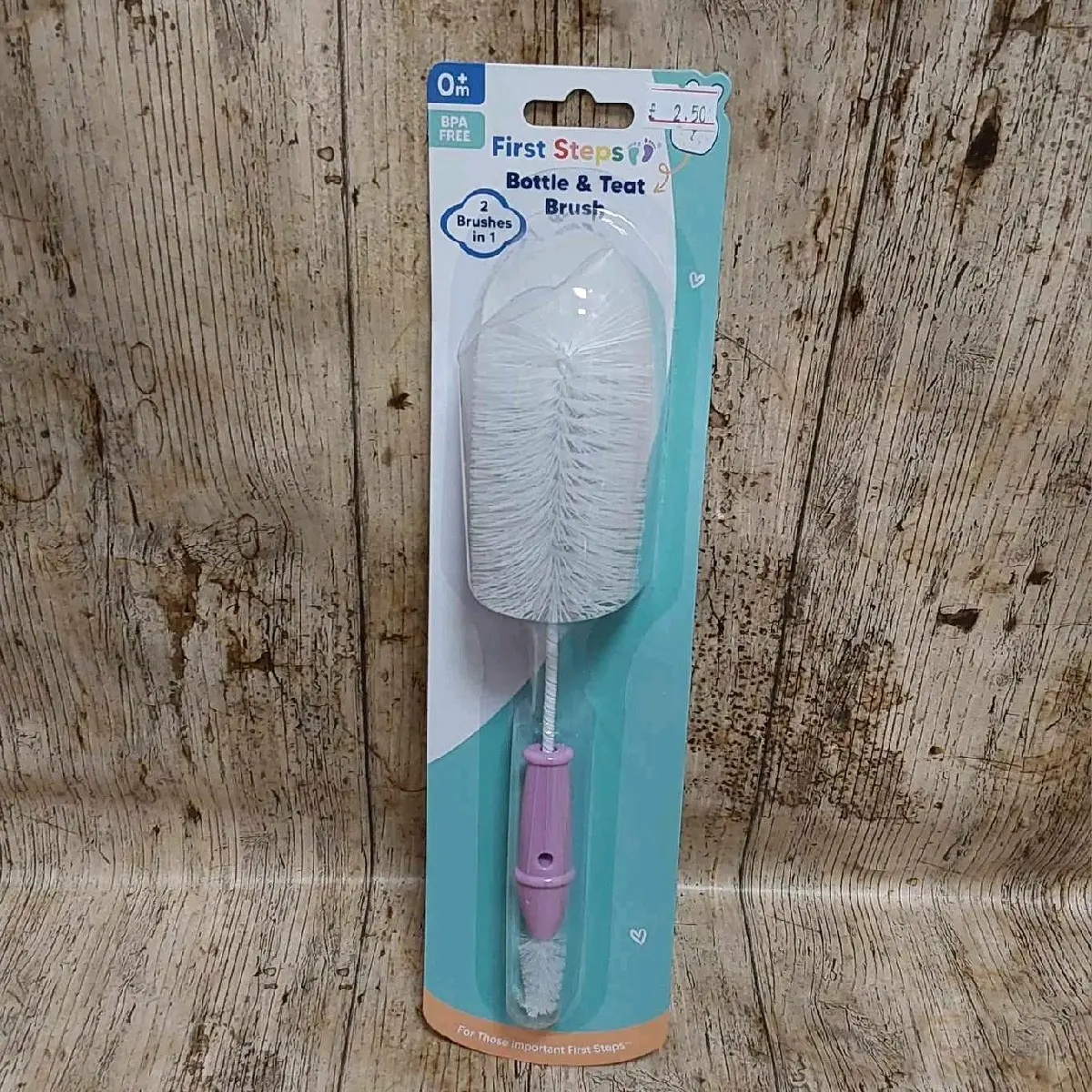 Pink, blue, and white bottle and teat brush